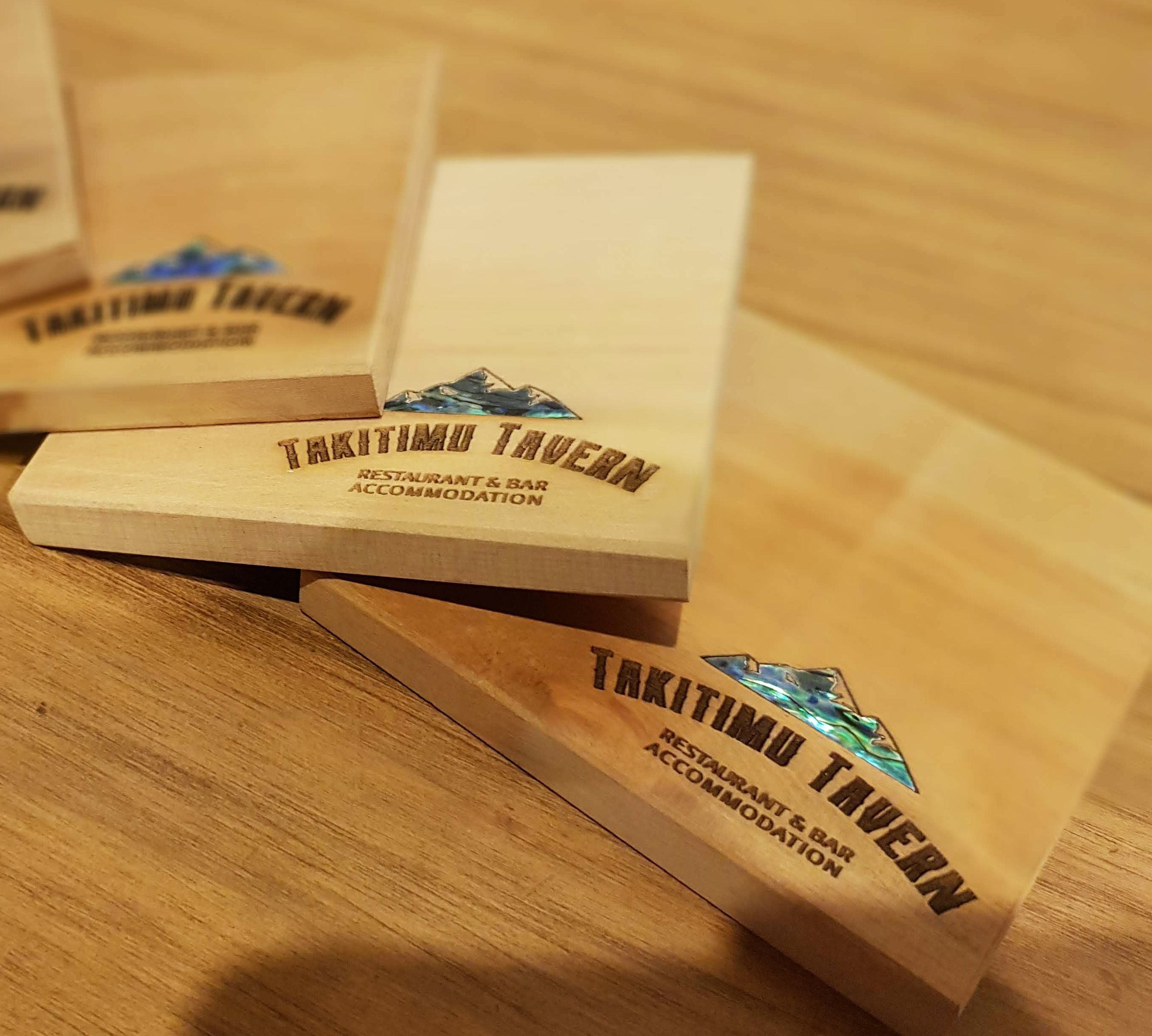 Branded Recycled Rimu Coasters laser engraved with our logo for corporate gifts